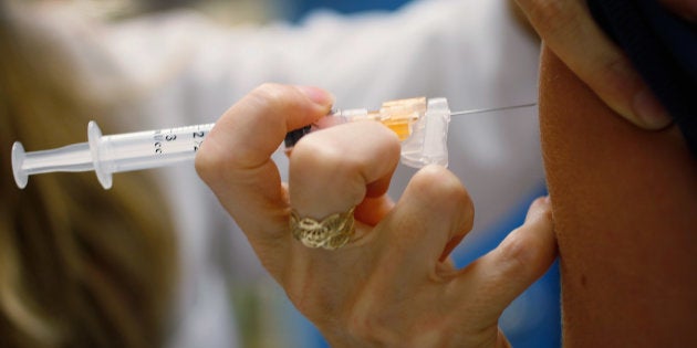 MIAMI, FL - SEPTEMBER 21: University of Miami pediatrician, Judith L. Schaechter, M.D., gives an HPV vaccination to a 13-year-old girl in her office at the Miller School of Medicine on September 21, 2011 in Miami, Florida.