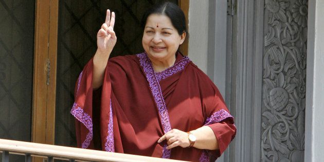 FILE PHOTO - J. Jayalalithaa, leader of Anna Dravida Munetra Khazhgam (AIADMK) flashes a victory sign toward her supporters from the balcony of her residence after winning state election in the southern Indian city of Chennai May 13, 2011. REUTERS/Babu/File Photo