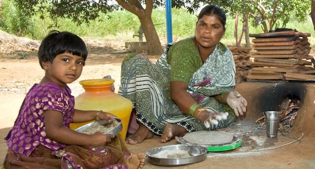 A mother prepares flat bread from pearl millet in Andhra Pradesh.
