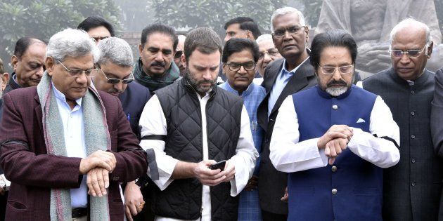 Opposition members check watches, look at their phone, while staging a protest near the Gandhi Statue inside Parliament premises over demonetisation, on 8 December, 2016 in New Delhi, India.