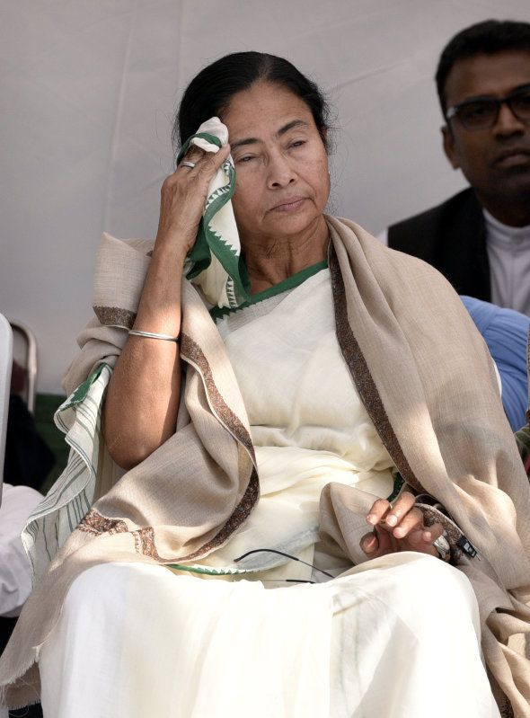 TMC leader Mamata Banerjee wipes her face during the dharna against demonetization, at Jantar Mantar on November 23, 2016 in New Delhi, India. In a show of strength, Bengal Chief Minister Mamata Banerjee, backed by JD(U), SP, NCP and AAP, on Wednesday held a demonstration against demonetisation in New Delhi and ramped up attack on Prime Minister Narendra Modi, alleging the country was not safe in his hands. (Photo by Mohd Zakir/Hindustan Times via Getty Images)