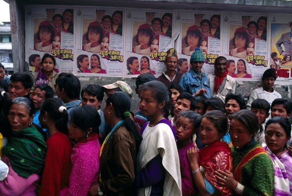 People in a queue outside a cinema hall for buying a ticket for an Indian movie. Sikkim, Inida.