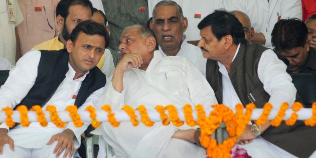 LUCKNOW, INDIA - NOVEMBER 3: Uttar Pradesh Chief Minister Akhilesh Yadav talking to his father and SP chief Mulayam Singh yadav while Shivpal Yadav and others look on during a 'Vikas Rath Yatra', flagged off by Samajwadi Party President Mulayam Singh, at La Martiniere Ground on November 3, 2016 in Lucknow, India.