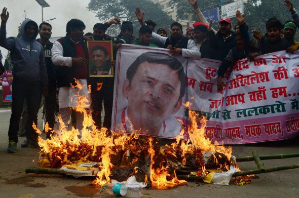 Supporters of Uttar Pradesh's Chief Minister Akhilesh Yadav burn the symbolic last ride effigy of Amar Singh, as they protest against the evictions of Akhilesh from Samajwadi Party for 6 years.