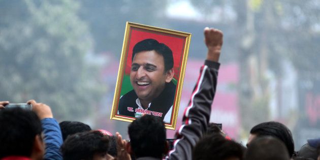 An Indian supporter of Uttar Pradesh's Chief Minister Akhilesh Yadav holds the photograph of Akhilesh Yadav as they protest against the evictions of Akhilesh Yadav from Samajwadi Party for 6 years , in Allahabad on December 31,2016.
