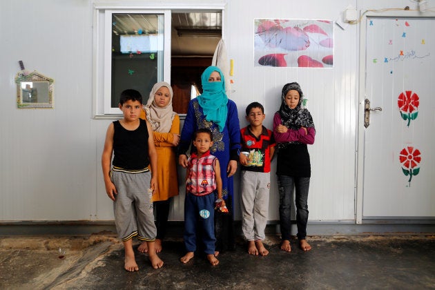 Rasha Inha, 30, the Syrian widow of a rebel fighter, poses for a photograph with her children in Zaatari camp in Jordan, October 14, 2016.