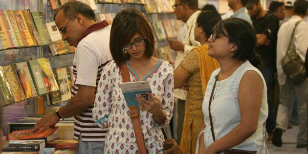 Visitors read books displayed at the 20th Delhi Book Fair organized by the Indian Trade Promotion Organisation (ITPO) and Fedration of Indian Publishers (FIP) in Pragati Maidan.
