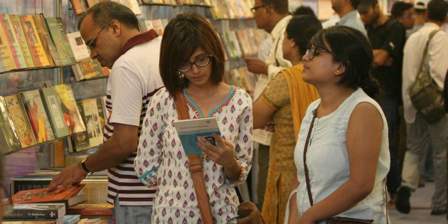 Visitors read books displayed at the 20th Delhi Book Fair organized by the Indian Trade Promotion Organisation (ITPO) and Fedration of Indian Publishers (FIP) in Pragati Maidan.