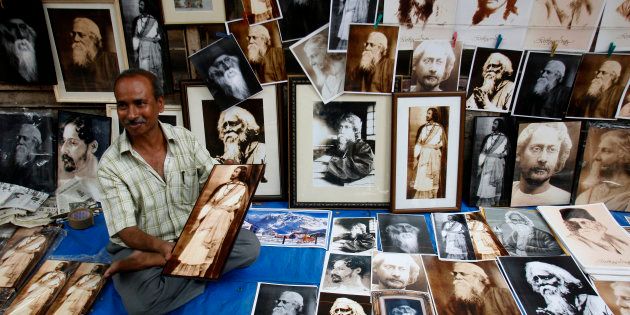 A street vendor in Kolkata sells photographs of Indian poet Rabindranath Tagore on a pavement during celebrations of his 147th birth anniversary.