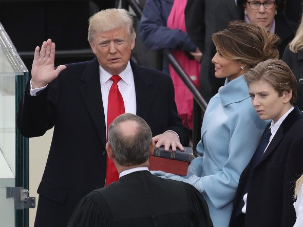 Supreme Court Justice John Roberts (2L) administers the oath of office to U.S. President Donald Trump (L) as his wife Melania Trump holds the Bible and son Barron Trump looks on, on the West Front of the U.S. Capitol on January 20, 2017 in Washington, DC.