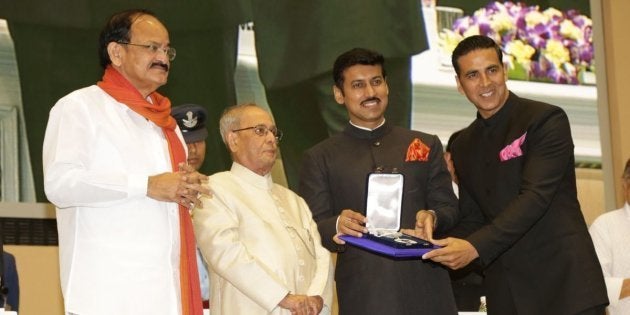 Akshay Kumar receiving the Best Actor National Award from President Pranab Mukherjee in New Delhi while I&B Minister M. Venkaiah Naidu and Minister of State Rajyavardhan Rathore look on