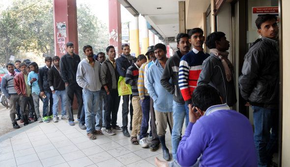 People stand in queue outside the ICICI Bank ATM machine to withdraw cash in sector-14, on December 29, 2016 in Gurgaon, India.