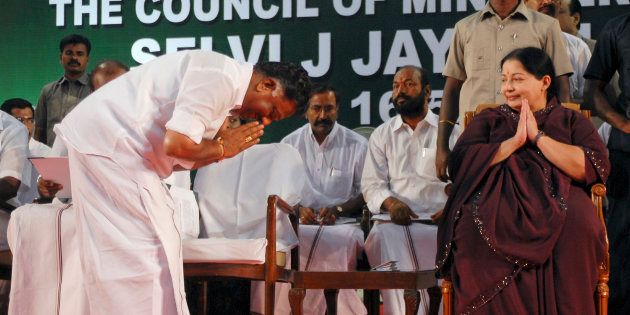 O. Paneerselvam bows to J. Jayalalithaa (R) before taking his oath as state's finance minister during a swearing-in ceremony at Madras University Centenary Auditorium in Chennai May 16, 2011.