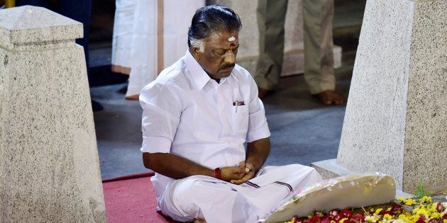 Tamil Nadu Chief Minister O Panneerselvam sitting in a meditation in front of late J Jayalalithaa's burial site at the Marina Beach in Chennai on Tuesday.