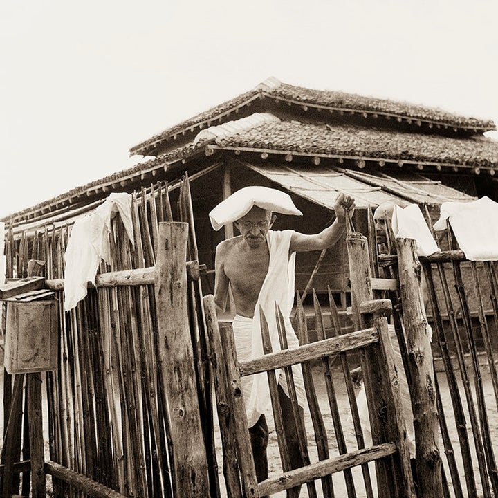 Mahatma Gandhi in front of his office hut, Sevagram Ashram, 1940.