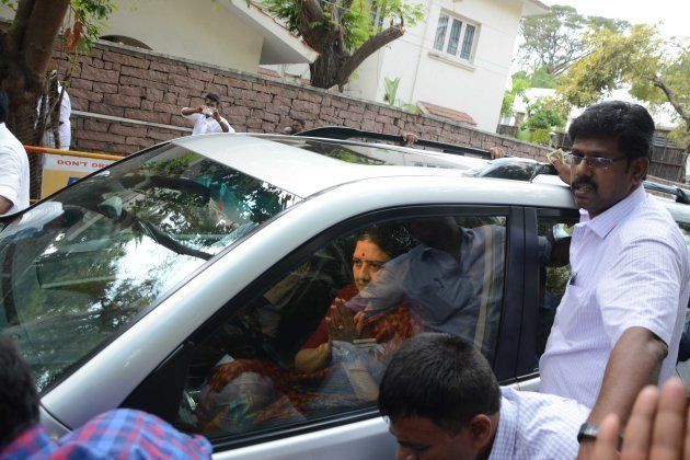 Indian Anna Dravida Munnetra Kazhagam (AIADMK) party leader V.K. Sasikala gestures to party members and supporters as she leaves to surrender to authorities, following a Supreme Court ruling, in Chennai on Febuary 15, 2017.