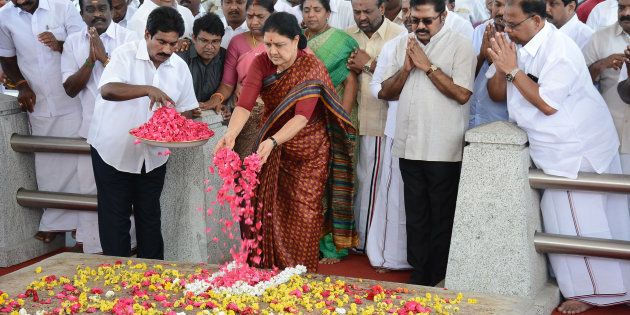 All India Anna Dravida Munnetra Kazhagam (AIADMK) leader VK Sasikala pays her respects at the memorial for former state chief minister Jayalalithaa Jayaram before leaving to surrender to authorities, following a Supreme Court ruling, in Chennai on Febuary 15, 2017. India's Supreme Court jailed the annointed next leader of Tamil Nadu for four years for corruption on February 14, heightening the turmoil in a state still reeling from the death of its long-time matriarch. VK Sasikala was told to surrender immediately to prison authorities after judges overturned her acquittal in a long-running 'disproportionate assets' case that also involved her late mentor Jayalalithaa Jayaram.