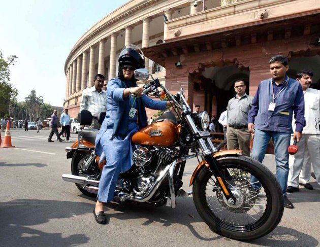 Ranjeet Ranjan, Congress party MP from Supaul, Bihar and wife of Pappu Yadav arrives at Parliament House on her Harley Davidson bike on the occasion of International Women's Day during the Parliament Budget Session on March 8, 2016 in New Delhi, India.