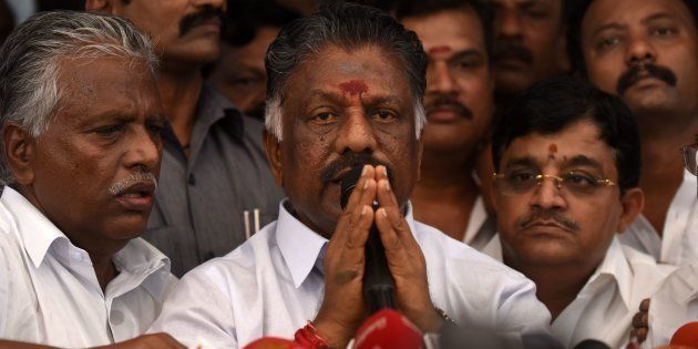 Acting chief minister O Panneerselvam (C) of the southern Indian state of Tamil Nadu gestures during a press conference at his home in Chennai on February 14, 2017.