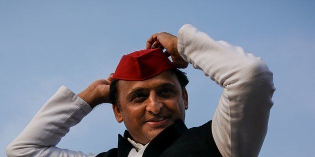 Uttar Pradesh state Chief Minister Akhilesh Yadav adjusts his cap during a election rally in Agra.