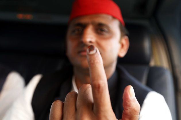 Uttar Pradesh state Chief Minister Akhilesh Yadav Shows his marked finger one day after casting his vote as he flies between election campaign venues in Uttar Pradesh.