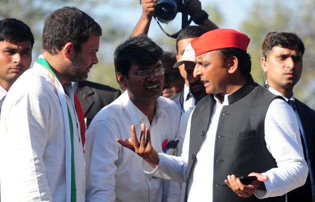 Chief Minister of Uttar Pradesh and Samajwadi Party leader Akhilesh Yadav (R) and Congress Party vice- President Rahul Gandhi (L) speak as they take part in a joint roadshow in support of their state assembly election party candidates in Allahabad on February 21, 2017.