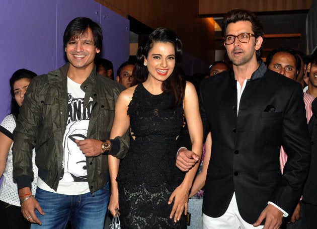 Indian Bollywood actors Hrithik Roshan (R) and Vivek Oberoi (L) pose with actress Kangana Ranaut (C) during a promotional event for the forthcoming Hindi film Krrish 3 Halloween party in Mumbai late October 30, 2013.