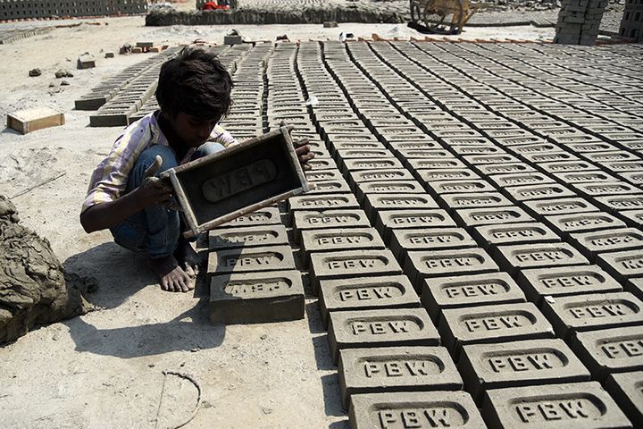 Pawan Kumar (name changed) moulds up to 200-300 bricks a day. When I asked how old he is, he shrugs and turns to his parents. "About 13 or 14," replies his mother.