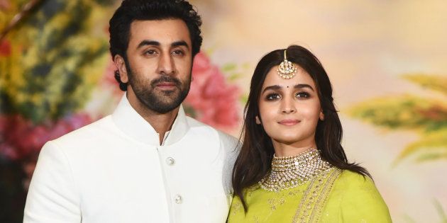 Indian Bollywood actors Ranbir Kapoor (L) and Alia Bhatt pose for a picture during the wedding reception of actress Sonam Kapoor and businessman Anand Ahuja in Mumbai late on May 8, 2018. (Photo by Sujit Jaiswal / AFP) (Photo credit should read SUJIT JAISWAL/AFP/Getty Images)