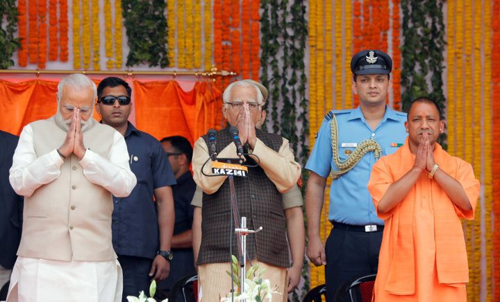 Prime Minister Narendra Modi (L), Uttar Pradesh governor Ram Naik (C) and India?s ruling Bharatiya Janata Party (BJP) leader Yogi Adityanath (R) greet a gathering before Adityanath takes an oath as the new Chief Minister of India?s most populous state of Uttar Pradesh during a swearing-in ceremony in Lucknow, India, March 19, 2017. REUTERS/Pawan Kumar