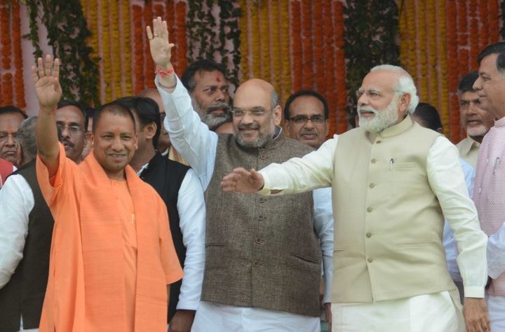 LUCKNOW, INDIA - MARCH 19: BJP President Amit Shah, UP CM Yogi Adityanath and Prime Minister Narendra Modi with other party leaders during the swearing-in ceremony at Lucknow's sprawling Smriti Upvan complex, on March 19, 2017 in Lucknow, India. BJP MP Yogi Adityanath was sworn in as the 21st Chief Minister of Uttar Pradesh Sunday afternoon, along with two deputies Keshav Prasad Maurya and Dinesh Sharma, ending the BJPs 15-year wait for power in India's bellwether state. Former UP chief minister Akhilesh Yadav, along with his father and Samajwadi Party supremo Mulayam Singh Yadav were also present at the oath taking ceremony. (Photo by Ashok Dutta/Hindustan Times via Getty Images)