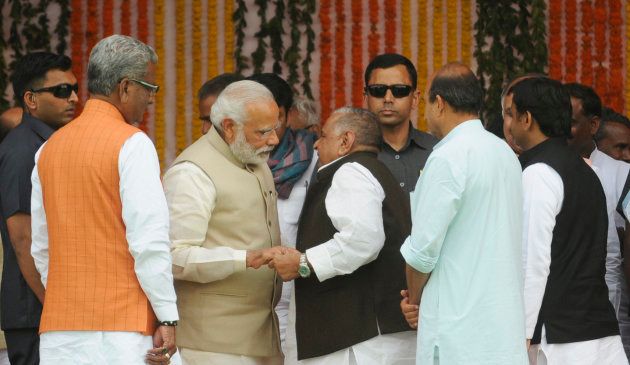 Prime Minister Narendra Modi interacting with former SP chief Mulayam Singh Yadav as well as former UP CM Akhilesh Yadav on the dais during the swearing-in ceremony at Lucknow's sprawling Smriti Upvan complex, on March 19, 2017.