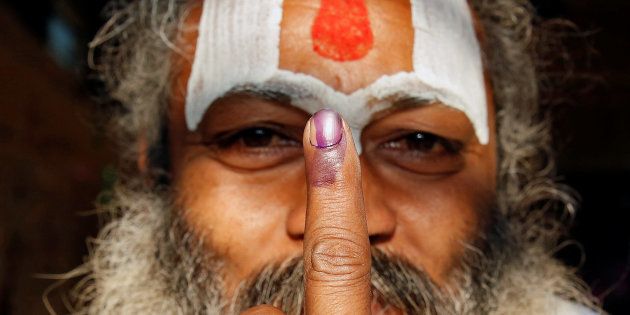 A Sadhu, or Hindu holy man shows his ink marked finger after voting during the state assembly election, in the town of Ayodhya, in Uttar Pradesh.