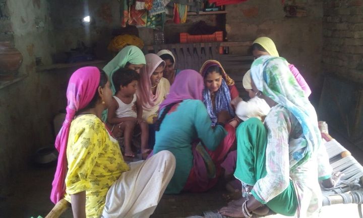Seema Prajapat teaches a group of women in her village in Rajasthan.