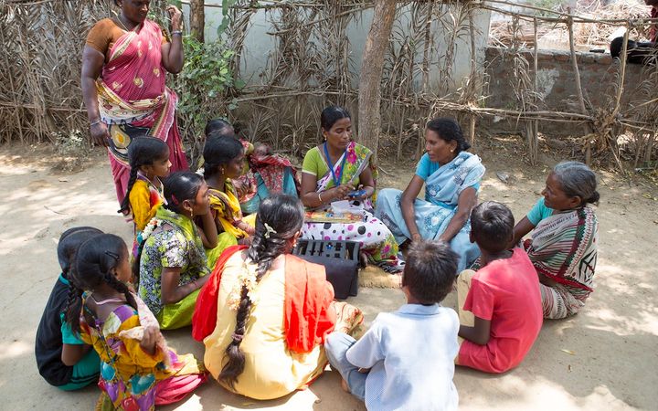 Bujji teaches a group of women in her village in Andhra Pradesh.