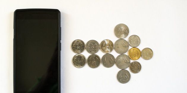 Arrow of coins from mobile phone. Mobile phone with indian currency set on a white background. Denoting payment through mobile and mobile wallets