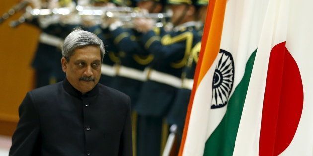 Indian Defense Minister Manohar Parrikar walks past the Indian and Japanese flags as he inspects the honour guard before talks with his Japanese counterpart Gen Nakatani (not pictured) at the defense ministry in Tokyo.