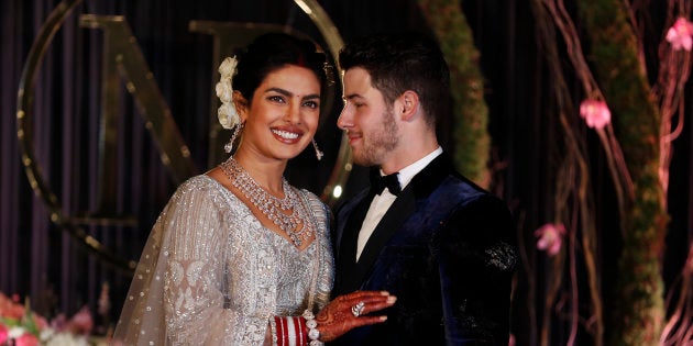 Bollywood actress Priyanka Chopra and musician Nick Jonas stand for photographs at their wedding reception in New Delhi, India, Tuesday, Dec. 4, 2018. (AP Photo/Altaf Qadri)