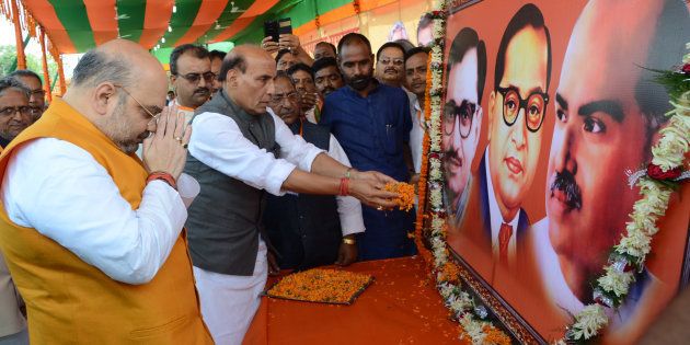 BJP National President Amit Shah and Union Home Minister Rajnath Singh paying floral tributes to the Portraits of Pandit DeenDayal Upadhyaya, Bhimrao Ambedkar and Shyama Prasad Mukherjee before party workers'convention at Gandhi Maidan on April 14, 2015 in Patna.