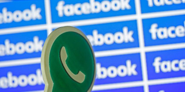 A 3D printed Whatsapp logo is seen in front of a displayed Facebook logo in this illustration taken April 28, 2016. REUTERS/Dado Ruvic/Illustration