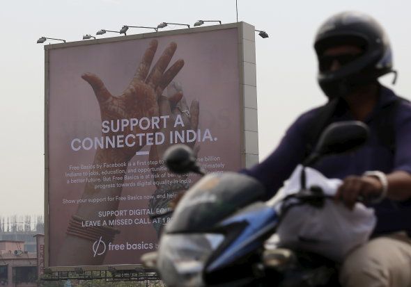 A motorist rides past a billboard displaying Facebook's Free Basics initiative in Mumbai, India, December 30, 2015. REUTERS/Danish Siddiqui