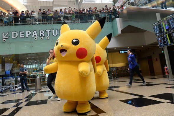 Performers dressed as the Pokemon Go virtual reality game mascot Pikachu
