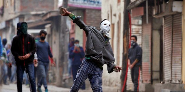 A demonstrator hurls a stone towards the Indian police during an anti-India protest in Srinagar, November 4, 2016.