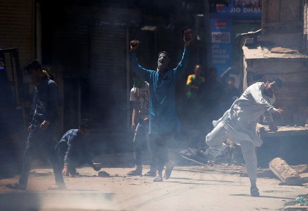 Supporters of Jammu Kashmir Liberation Front (JKLF), a Kashmiri separatist party, shout slogans and hurl stones towards Indian police during a protest against what the supporters say was use of force on protesting students, in Srinagar April 21, 2017.