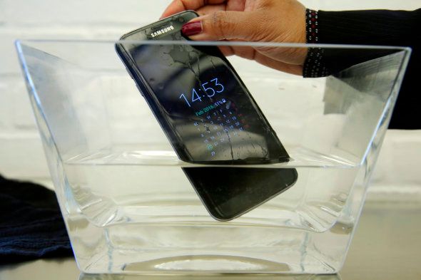 FILE - In this Feb. 22, 2016, file photo, a waterproof Samsung Galaxy S7 Edge mobile phone is submersed in water during a preview of Samsung's flagship store, Samsung 837, in New York's Meatpacking District. Consumer Reports says Samsungs Galaxy S7 Active malfunctions in water despite being marketed as water resistant, though the regular S7 and S7 Edge models passed. Consumer Reports rates the S7 and S7 Edge phones as Excellent and the Active likely would have joined them. Instead, Consumer Reports isnt recommending the model because two phones failed after being submerged in water. (AP Photo/Richard Drew, File)