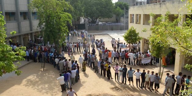 NEW DELHI, INDIA APRIL 23: Voters line up at a polling booth to cast their vote for MCD polls at Tuglakabad, New Delhi.(Photo by K Asif/India Today Group/Getty Images)