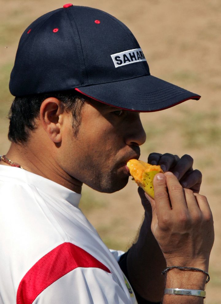 India's star batsman Sachin Tendulkar eats a mango during a break in a practice session ahead of the first test match against Pakistan in the northern city of Mohali, March 6, 2005. The first five-day test match starts in the city on Tuesday. The Pakistani team is on its first visit to India in six years on a fifty-day tour to play three tests and six one-dayers as both countries continue their cautious peace process. REUTERS/Kamal Kishore KK/AT