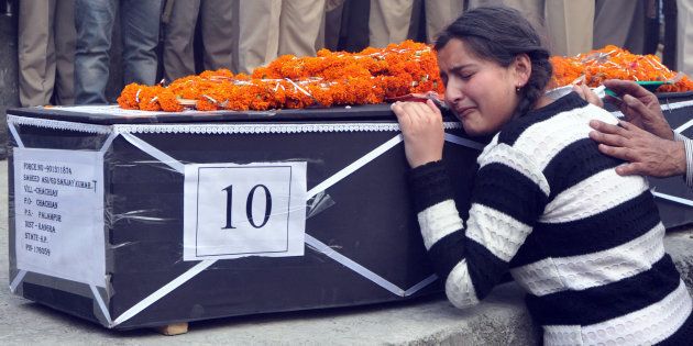 Daughter of martyr Sanjay Kumar, who was killed in Maoist attack in Sukma, Chhattisgarh, wails near his body during his funeral at his native village (Chechain) Nagri on April 25, 2017 near Dharamsala, India. (Photo by Shyam Sharma/Hindustan Times via Getty Images)
