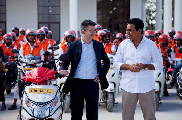 Uber CEO Travis Kalanick, center, gestures to Telangana state minister for Information and Technology, Municipal Administration and Urban Development, K T Rama Rao, right, during the launch of Uber's bike-sharing product, uberMOTO, in Hyderabad, India, Tuesday, Dec. 13, 2016. (AP Photo/Mahesh Kumar A.)