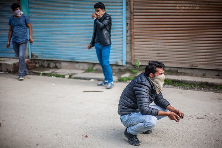 SRINAGAR, KASHMIR, INDIA - MAY 04: Kashmiri student throw stones at Indian government forces, during fresh protest, against the attack by Indian government forces on students, on May 04, 2017, in Srinagar, the summer capital of Indian administered Kashmir, India. Fresh clashes erupted between Kashmiri students and Indian government forces Today in Srinagar. Kashmiri students have been protesting and clashing with Indian forces continuously after an attack by forces on college students in south Kashmirï¿½ pulwama district last month. (Photo by Yawar Nazir/Getty Images)